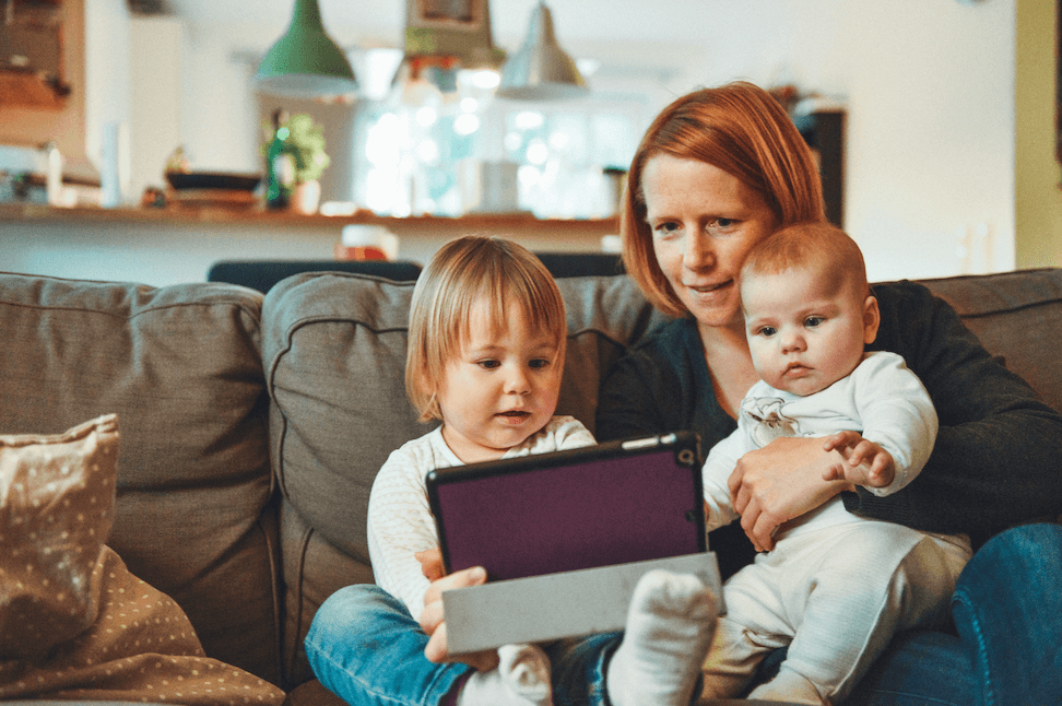 mother with two children sitting on the couch