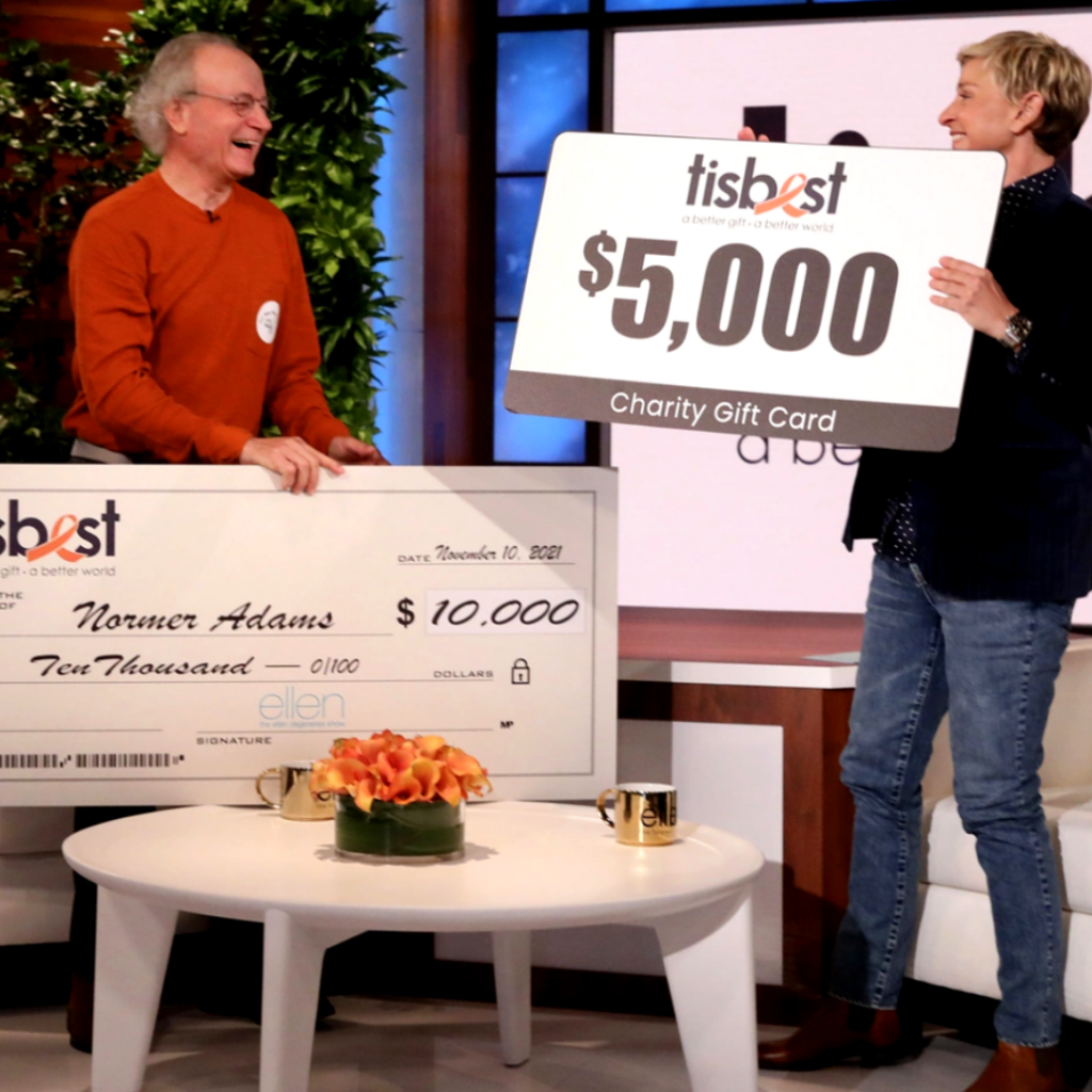 Normer Adams of Cat Man Do receives a check and TisBest Charity Gift Card on The Ellen DeGeneres Show.