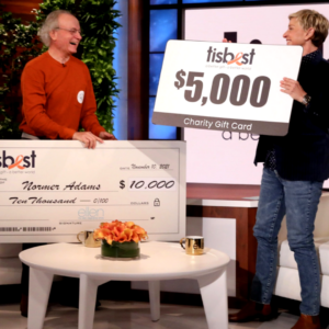 Normer Adams of Cat Man Do receives a check and TisBest Charity Gift Card on The Ellen DeGeneres Show. 