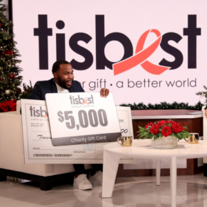 Houston Elementary School Teacher Joshua Martin receives a check and TisBest Charity Gift Card on The Ellen DeGeneres Show.