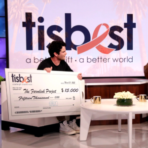 Aidan Reilly receives a TisBest check on The Ellen DeGeneres Show.