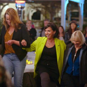 Double leg amputee Christi Hoehn is guided onto the stage at The Ellen DeGeneres Show.